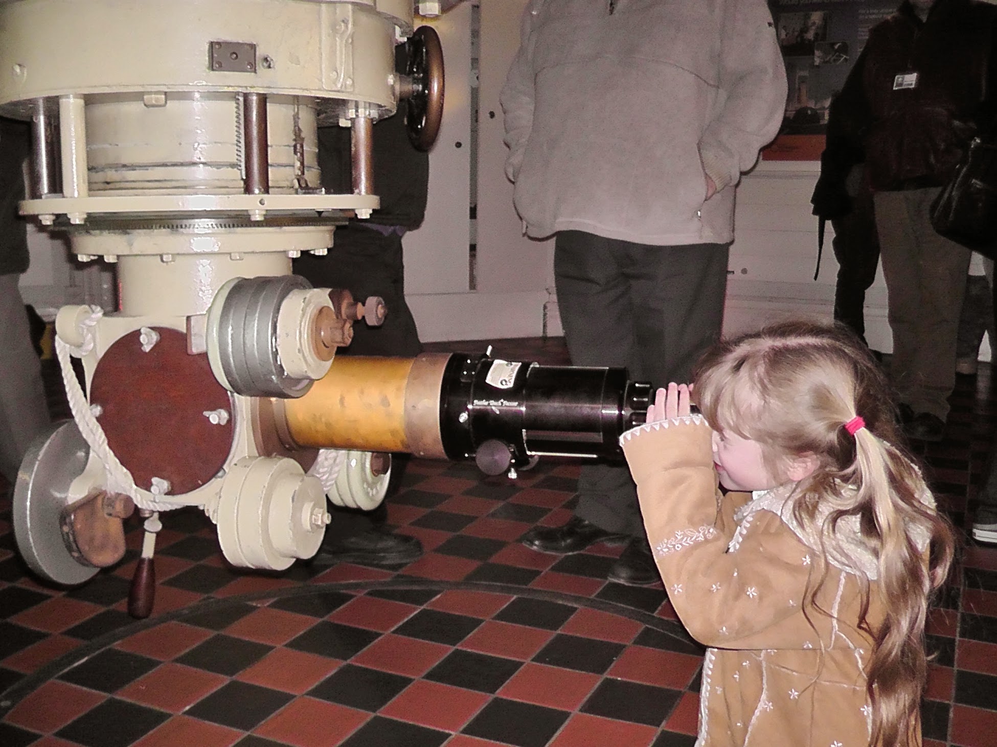 Gracie looking through a telescope